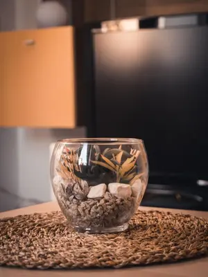 a glass bowl filled with rocks on a table at Apartments STARI TIGER in Bohinj