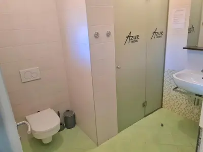 a bathroom with a toilet and a sink at AZUR ROOMS LJUBLJANA in Ljubljana