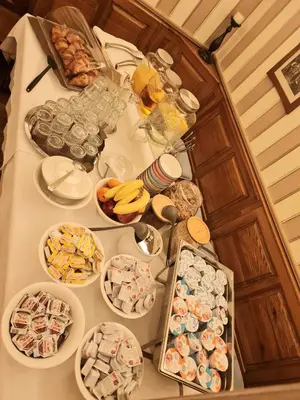 a table filled with food and drinks and bowls of food at AZUR ROOMS LJUBLJANA in Ljubljana