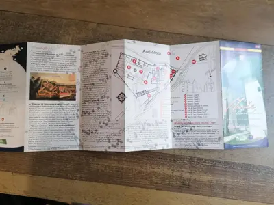 two pages of an open book on a table at Hiša Žičanka in Loče pri Poljčanah