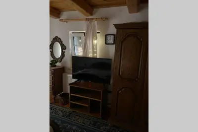 a living room with a wooden cabinet and a mirror at Apartma Jožica in Tonček in Sveti Jurij ob Ščavnici
