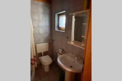 a small bathroom with a toilet and a sink at Apartma Jožica in Tonček in Sveti Jurij ob Ščavnici