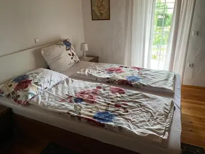 a bedroom with two beds and a window at Apartma Jožica in Tonček in Sveti Jurij ob Ščavnici