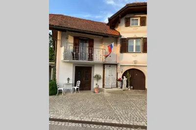 a house with a balcony and a courtyard at Apartma Jožica in Tonček in Sveti Jurij ob Ščavnici