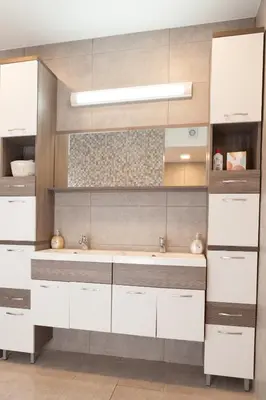 a bathroom with white cabinets and a sink at Bella Belca in Mojstrana