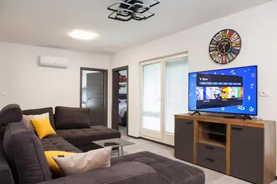 a living room with a couch and a flat screen tv at Bella Belca in Mojstrana