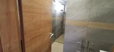 a bathroom with a shower with a glass door at Apartmaji Tmaynka in Tolmin