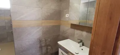 a bathroom with a sink and a toilet and a mirror at Apartmaji Tmaynka in Tolmin