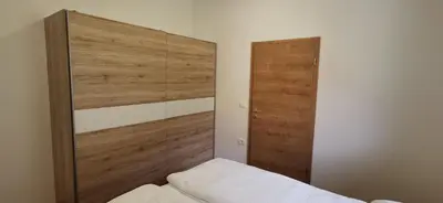 a bedroom with a wooden headboard and a bed at Apartmaji Tmaynka in Tolmin