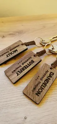 a group of wooden signs on a table with scissors at Apartmaji Tmaynka in Tolmin