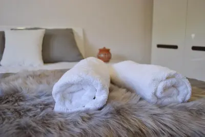 a pair of towels sitting on top of a bed at Apartma Ksela in Mala Nedelja
