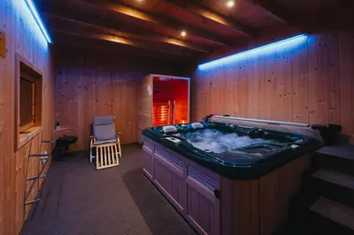 a jacuzzi tub in a room with wooden walls at Apartma Ksela in Mala Nedelja