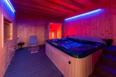 a jacuzzi tub in a room with purple lights at Apartma Ksela in Mala Nedelja