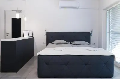 a bedroom with a large bed with a black headboard at Point Zero in Ljubljana