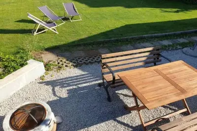 two chairs and a wooden bench and a table at Huge BBQ Garden 1, Basement app Two Bathrooms, AC, Free Parking in Ljubljana
