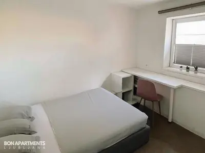 a bedroom with a bed and a desk and a window at Huge BBQ Garden 1, Basement app Two Bathrooms, AC, Free Parking in Ljubljana