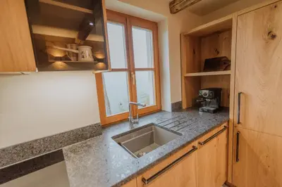 a kitchen with a sink and a window at Cottage Planska koča in Vitanje