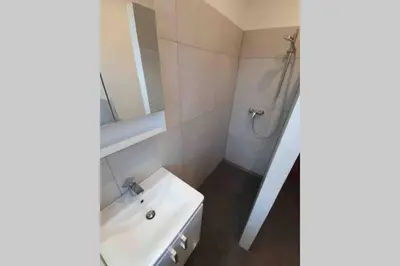 a white bathroom with a sink and a mirror at The Villa in Ljubljana