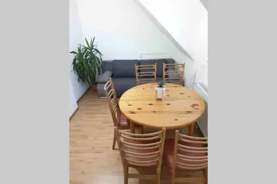 a dining room with a wooden table and chairs at The Villa in Ljubljana