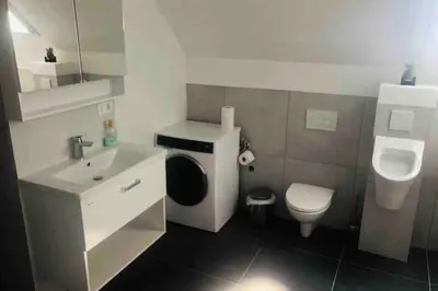 a small bathroom with a toilet and a sink at The Villa in Ljubljana