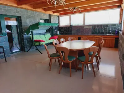 a dining room with a table and chairs in a room at Ranč Stojnšek in Rogaška Slatina