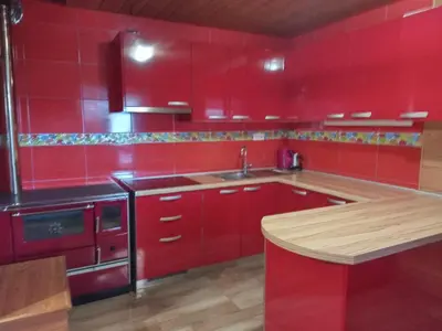 a red kitchen with red cabinets and a sink at Ranč Stojnšek in Rogaška Slatina