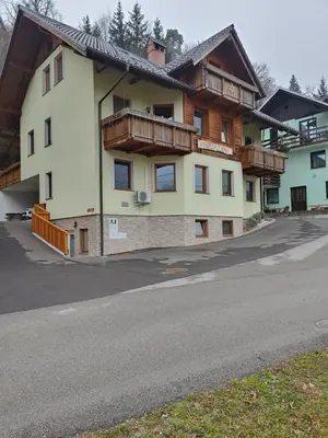 a building with wooden balconies on the side of a road at Studio Maki in Bled