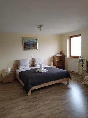 a bedroom with a bed with a teddy bear on it at Studio Maki in Bled