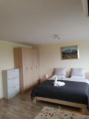 a bedroom with a bed with a white swan on it at Studio Maki in Bled