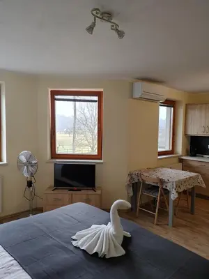 a room with a bed with a swan on it at Studio Maki in Bled