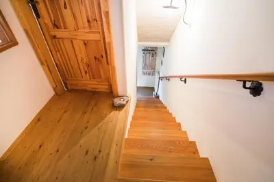 a hallway with a wooden door and a wooden floor at Apartma Lojz in Bovec
