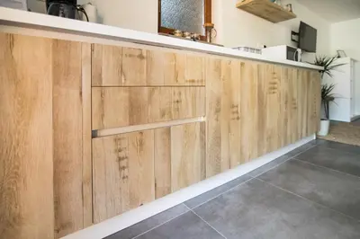 a row of wooden garage doors in a kitchen at Apartma Lojz in Bovec