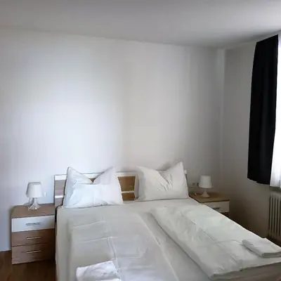 a bedroom with a large bed with white sheets and pillows at APARTMAJI KISILAK in Rogašovci