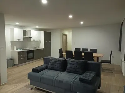 a living room with a couch and a table with chairs at APARTMAJI KISILAK in Rogašovci