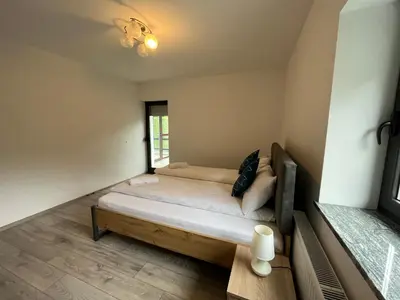 a bedroom with a bed and a window at Two Panorama Apartments in Bovec