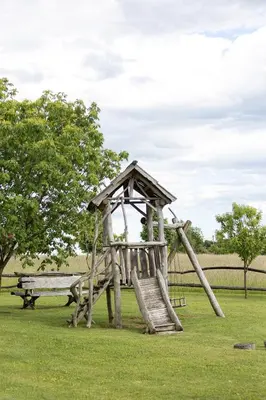 a playground with a slide and a bench at Holiday Home Ernest Železni with hot tub in Ivančna Gorica