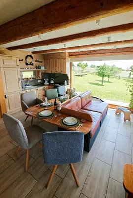 a living room with a couch and a table at Holiday Home Ernest Železni with hot tub in Ivančna Gorica
