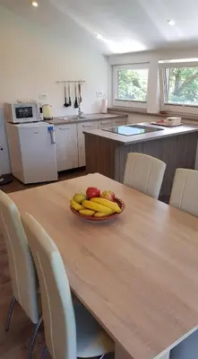a wooden table with a bowl of fruit on it at Apartma Cifra Begunje in Begunje na Gorenjskem