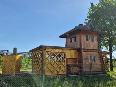 a building with a tower on top of it at Unique wooden holiday house in nature in Lukovica pri Domžalah
