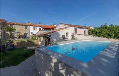 a person swimming in a swimming pool in a house at Beautiful Home In Skofije in Plavje