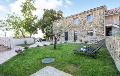 a yard with a bench in front of a house at Beautiful Home In Skofije in Plavje