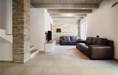 a living room with a couch and a tv at Beautiful Home In Skofije in Plavje