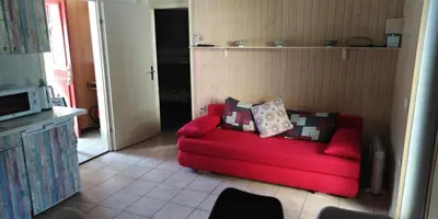 a red couch with pillows in a living room at Apartmán Perspekta 196 in Čatež ob Savi