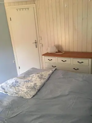 a bedroom with a bed and a desk and a drawer at Apartmán Perspekta 196 in Čatež ob Savi