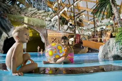 two children sitting in a pool at a water park at Apartmán Perspekta 196 in Čatež ob Savi