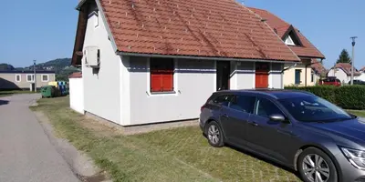 a blue car parked in front of a house at Apartmán Perspekta 196 in Čatež ob Savi