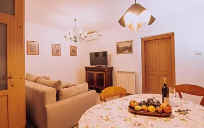 a living room with a table with a bowl of fruit on it at Hiša Orel (Orel House) in Križ