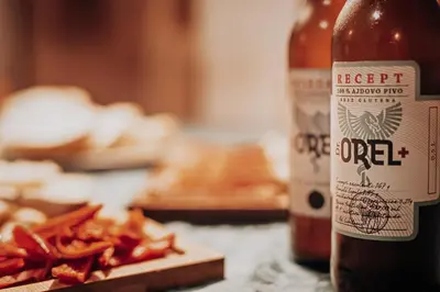 a bottle of beer sitting next to a pile of fries at Hiša Orel (Orel House) in Križ