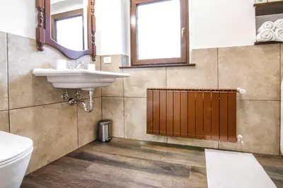 a bathroom with a sink and a toilet at Danilo's Resort, Vipavska dolina in Dobravlje