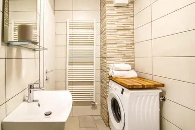 a bathroom with a washing machine and a sink at Danilo's Resort, Vipavska dolina in Dobravlje